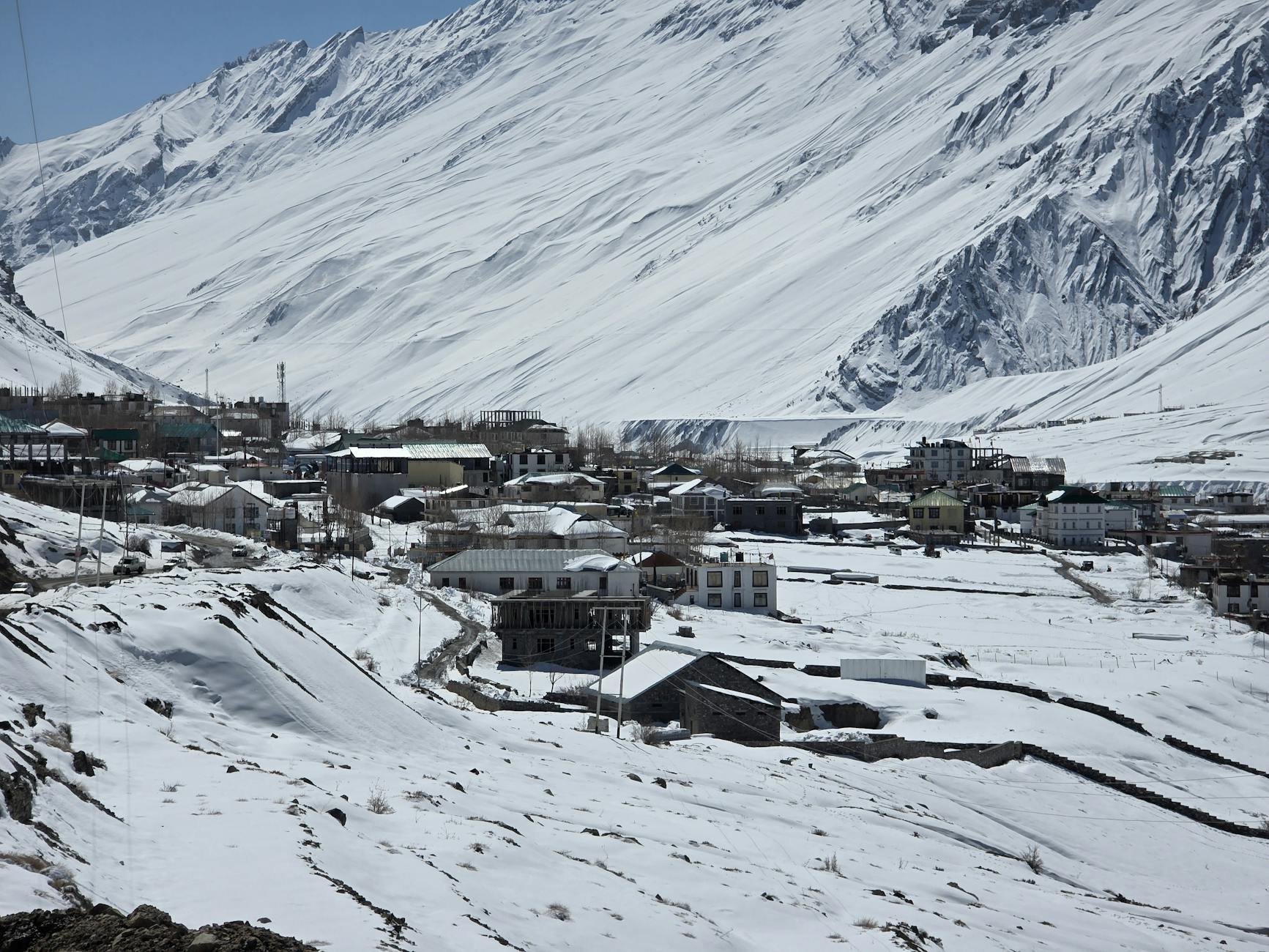 Spiti Valley Kaza village winter snow covered houses frozen valley Himachal