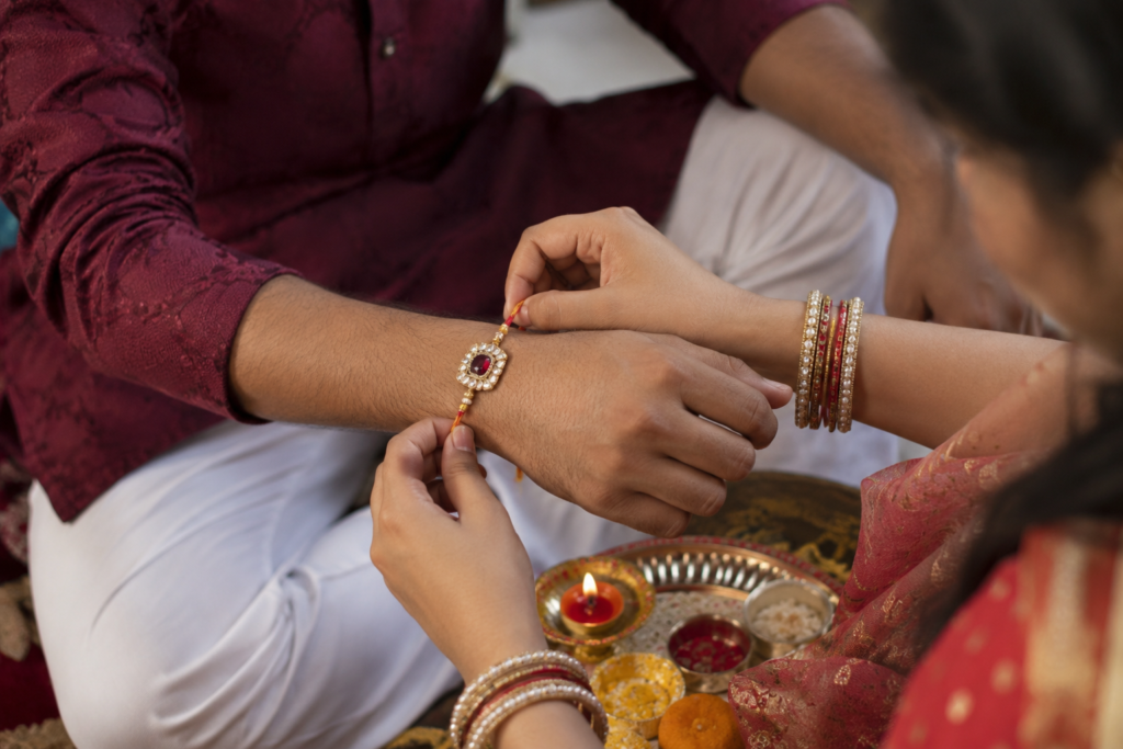 Raksha Bandhan sister tying rakhi brother wrist monsoon India festival
